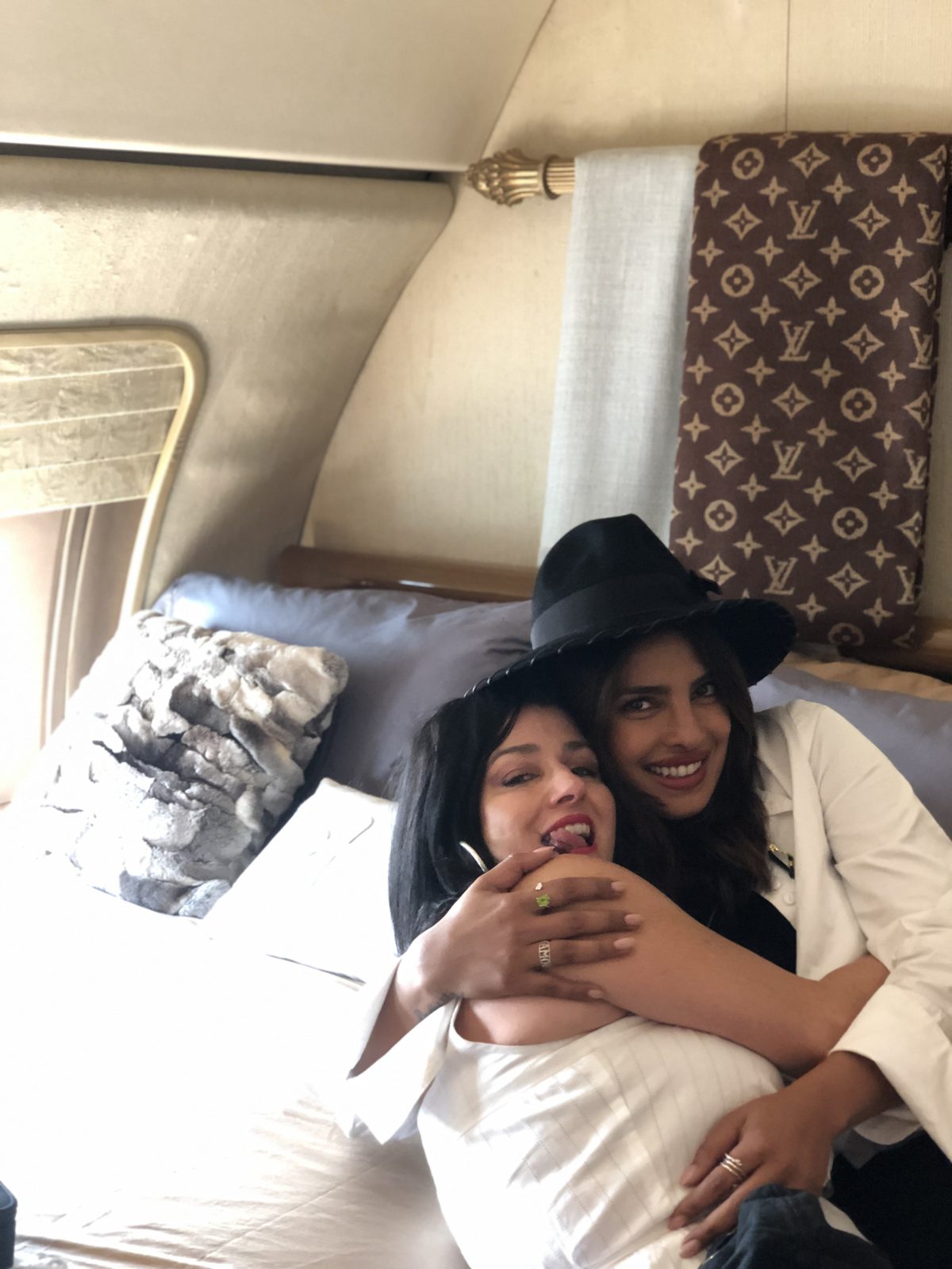 Denise Jonas and Priyanka Chopra sharing a hug on a plane